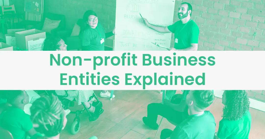 A presenter leading a workshop on non-profit business entities, using a whiteboard in a classroom setting surrounded by attentive listeners.